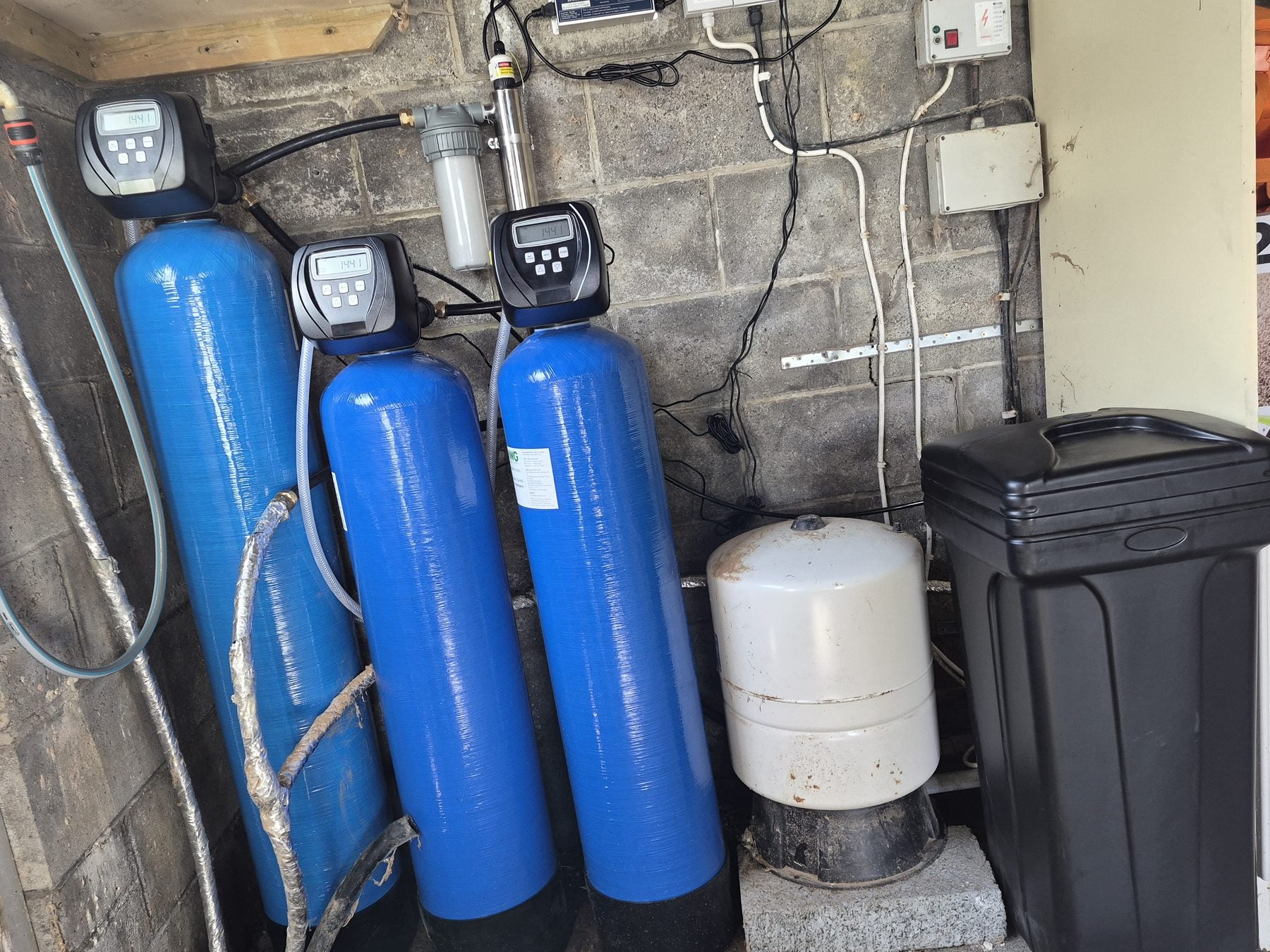 A whole-home water filtration system treating a private supply